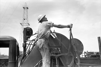 Winch Operator at Oil Well, Oklahoma City, Oklahoma, USA, Russell Lee, Farm Security Administration, August 1939