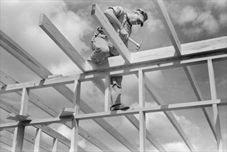 Carpenter Working on Framework of a Unit of a Migrant Camp, Sinton, Texas, USA, Russell Lee, Farm Security Administration, October 1939