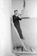 Close-up Portrait of Man Ringing Bell with Rock, Church of the Twelve Apostles, Trampas, New Mexico, USA, Russell Lee, Farm Security Administration, July 1940