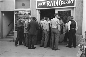 Crowd of Men Listening to World Series Baseball Game at Dixie Radio Service, St. George, Utah, USA, Russell Lee, Farm Security Administration, October 1940
