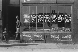 Two Children Standing in Doorway of Grocery Store, South Side, Chicago, Illinois, USA, Russell Lee, Farm Security Administration, April 1941
