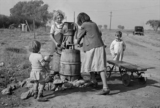 Children of Migrant Workers Fetching Water, American River Migrant Camp, San Joaquin Valley, California, USA, Dorothea Lange, Farm Security Administration, November 1936