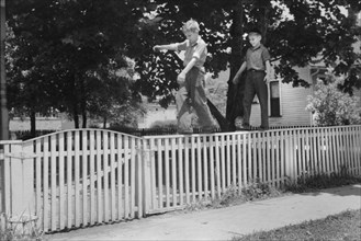 Two Boys Walking on Picket Fence, Washington, Indiana, John Vachon, Farm Security Administration, July 1941