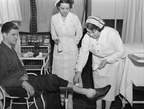 Nurse Tending to Injured Man's Wound, Public Health Service, Washington DC, USA, Carl Mydans, FSA/OWI Collection, November 1935