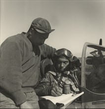 Pilot from 332nd Fighter Group Signing Form One Book, Indicating any Discrepancies of Aircraft, Prior to Take-off, Ramitelli, Italy, Toni Frissell, March 1945