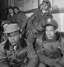 Tuskegee Airmen Attending Briefing, Foreground (left to right): Joseph L. "Joe" Chineworth, Memphis, TN, Class 44-E; Emile G. Clifton, San Francisco, CA, Class 44-B; Richard S. Harder, Brooklyn, NY, C...