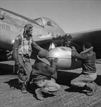 Tuskegee airman Edward C. Gleed, Lawrence, KS, Class 42-K, with two Unidentified Crewmen Adjusting External Drop Tank on Wing of a P-5/D Airplane, Ramitelli, Italy, Toni Frissell, March 1945