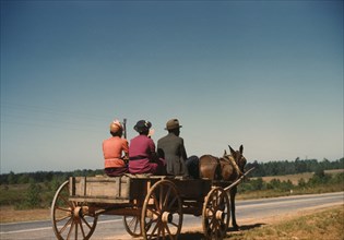 Three People Going to Town in Horse-Drawn Wagon on Saturday Afternoon, Greene County, Georgia, USA, by Jack Delano for Farm Security Administration, May 1941