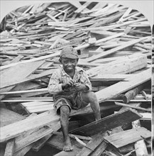 Portrait of Young Boy Sitting on Pile of Debris after Hurricane, Galveston, Texas, USA, Single Image of Stereo Card, 1900