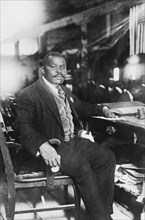 Marcus Garvey (1887-1940), Jamaican-Born Activist, Political Leader, Publisher, Entrepreneur and Proponent of Black Nationalism and Pan-Africanism Movements, Full-length Portrait seated at Desk, Bain ...