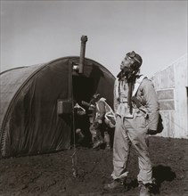 Pilot Newman C. Golden, Cincinnati, OH, Class 44-G, Scanning Skies, with Parachute Room in Background, Ramitelli, Italy, Toni Frissell, March 1945