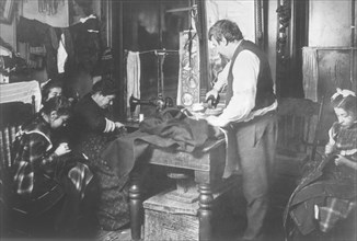 Family Working on Clothing in Tenement Apartment, New York City, USA, circa 1906