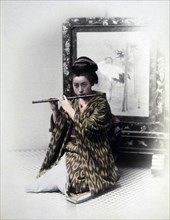 Japanese Female Flute Player, Hand Colored Albumen Photograph, circa 1860