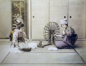 Two Japanese Women Spinning Cotton, Hand Colored Albumen Photograph, circa 1880