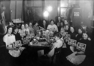 Seamstresses on Lunch Break, Holding Keep Smiling Signs, circa 1914