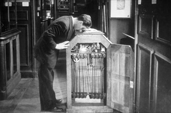 Man Looking into a Kinetoscope, Invented by Thomas A. Edison in 1889