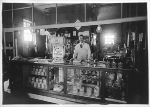 Clerk Standing by Cash Register in Grocery Store, 1929