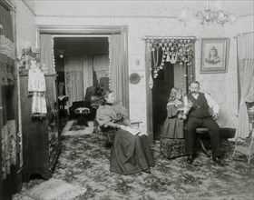 Couple and Daughter in Victorian Parlor, USA, circa 1890