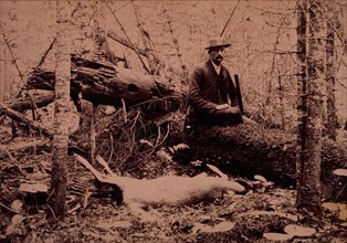 Hunter Seated on Log Next to Dead Animal, circa 1890