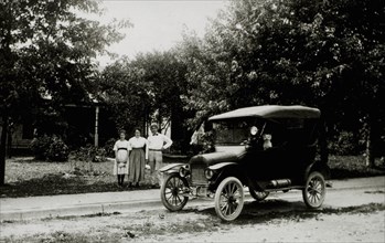 Family Standing Near Automobile With Dog Inside, USA, 1914