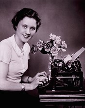 Smiling Woman Typing on Typewriter, circa 1930's