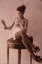 Partially Nude French Lingerie Model with Mirror and Lipstick, 1920