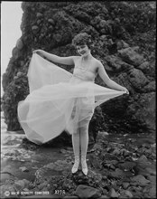 Actress Phyllis Haver, One of Mack Sennett's Bathing Beauties, Portrait in Flowing Bathing Suit at Beach, circa 1920