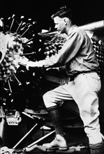 Charles Lindbergh Working on Engine of his Airplane, Spirit of Saint Louis, 1927