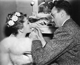 Joan Fontaine and Makeup Man on-set of the Film, "Blond Cheat", 1938
