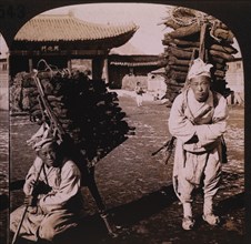 Two Men Carrying Logs, Korea, Single Image of Stereo Card, circa 1905