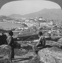 Two People Sitting atop Hill Looking at Harbor and Macau, Single Image of Stereo Card, circa 1910