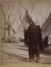 Sitting Bull Wrapped in Blanket Near Teepees on Reservation, Fort Randall, Dakota Territories, Stereo Card, circa 1882