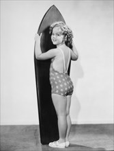 Shirley Temple, Standing with Surfboard, Portrait, 1934
