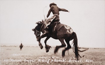 Rodeo Rider Norval Cooper on Bucking Bronco, Burwell, Nebraska, USA, circa 1919