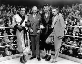 Max Baer (left), Primo Carnera (second from right), director W.S. Van Dyke (right) on-set of the Film, "The Prizefighter and the Lady", 1933