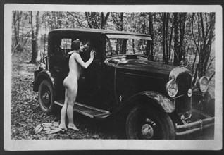 Nude Woman Beside Car Embracing another Woman Inside, 1925