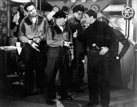 Edward Brophy, (center), Glenn Ford, Edward G. Robinson, (right), on-set of the Film, "Destroyer", 1943