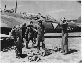 Dutch Pilots Putting on Gear Near Airplane as they Prepare for Air Raid on Japanese Forces During WWII, Dutch East Indies, 1942