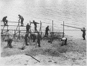 WWII Soldiers Constructing Barricade on Beach, from the British Documentary Film, "A Diary for Timothy", 1945