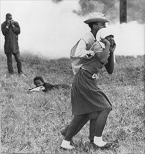 Civil Rights Demonstrator Helping Young Woman After Police Toss Smoke Bombs, Camden, Alabama, USA, 1965