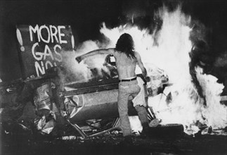 Gas Shortage Demonstrator in Front of Burning Car During Riot at Night, Levittown, Pennsylvania, USA, 1979