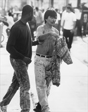 Bloodied Man Being Escorted to Safety During Riots Resulting from Rodney King's Verdict, Los Angeles, California, USA, 1992