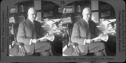 Colonel George W. Goethals Sitting at Desk Reading Documents, "Col. Goethals in Charge of the Panama Canal", Stereo Card, circa 1917