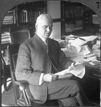 Colonel George W. Goethals Sitting at Desk Reading Documents, "Col. Goethals in Charge of the Panama Canal", Single Image of Stereo Card, circa 1917