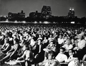 Large Crowd Listening to Classical Music Performed by New York Philharmonic Orchestra at Night, Central Park, New York City, USA, 1965