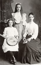 Mother with Two Daughters, one Holding String Instrument, Portrait, circa 1910