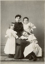Woman in Dark Dress with Three Young Children in White Dresses, Portrait, circa 1910