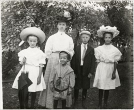 Woman with Two Boys and Two Girls, All Wearing Hats and one with Parasol, Outdoor Portrait, circa 1910