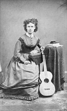 Seated Woman with Guitar, Cabinet Card, circa 1911