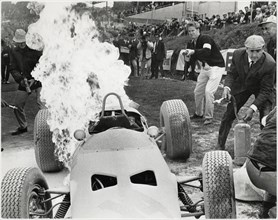 Technicians Attempt to Extinguish Flames of Burning Yamura Racer from the Film, "Grand Prix", MGM, 1966